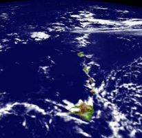 Satellite view of Hawaii showing the island chain in the Pacific Ocean, with some cloud cover in the region.