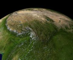 A satellite view of Earth's surface shows a detailed topographical image with mountains, green plains, and brown desert areas.